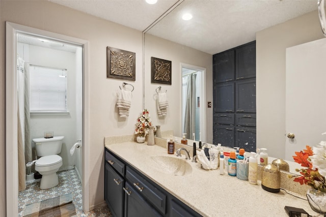 full bathroom with toilet, vanity, and recessed lighting