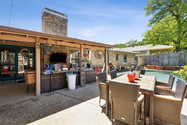 view of patio with fence, an outdoor hangout area, a fenced in pool, and outdoor dining area
