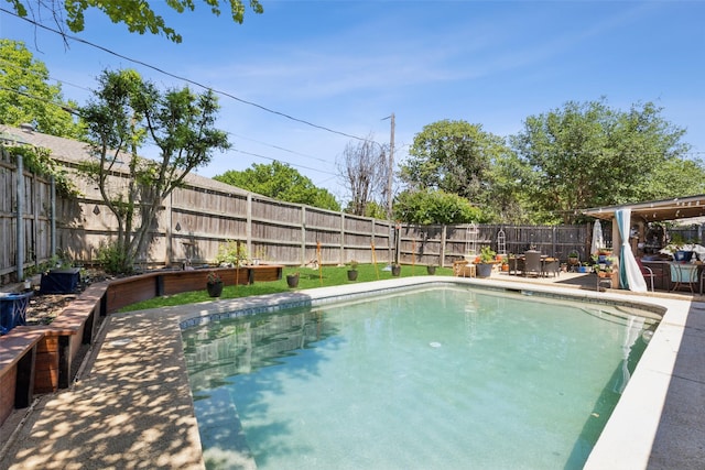 view of swimming pool with a fenced backyard, a fenced in pool, and a patio