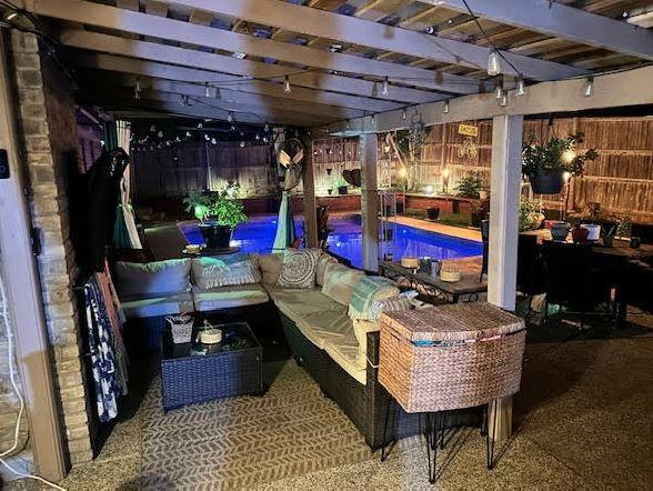 exterior space featuring a pergola, a fenced in pool, a fenced backyard, and an outdoor living space