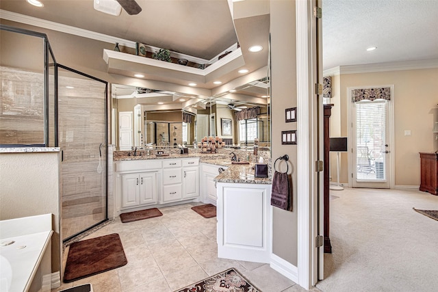bathroom featuring ornamental molding, ceiling fan, and a stall shower