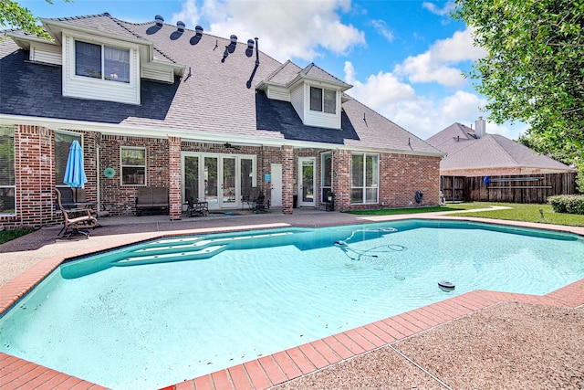 view of pool with fence, a patio, a fenced in pool, and french doors
