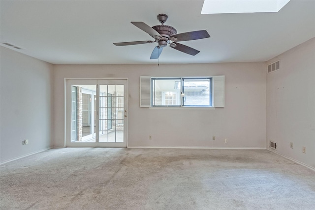 spare room featuring carpet floors, baseboards, and visible vents