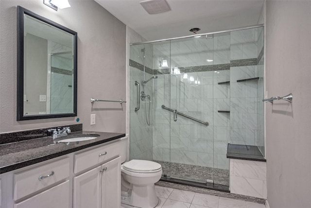 bathroom with toilet, a shower stall, marble finish floor, and vanity