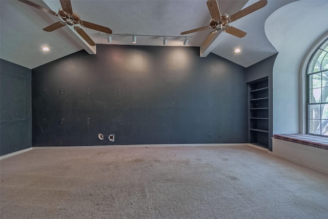 carpeted spare room with baseboards, ceiling fan, and lofted ceiling with beams