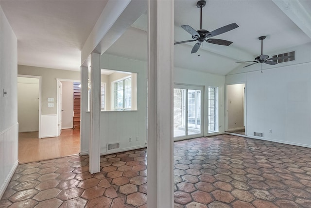 interior space featuring ceiling fan, visible vents, and lofted ceiling