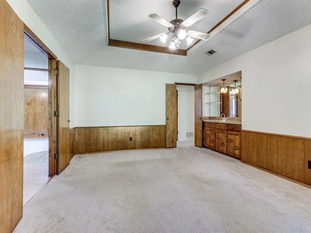 2011 Vicksburg Dr, Sachse, TX 75048 - unfurnished bedroom featuring a wainscoted wall, a textured ceiling, wood walls, visible vents, and light colored carpet