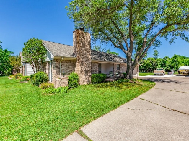 2011 Vicksburg Dr, Sachse, TX 75048 - view of front of home featuring a shingled roof, a chimney, brick siding, and a front yard