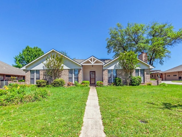 2011 Vicksburg Dr, Sachse, TX 75048 - view of front facade with a chimney, cooling unit, brick siding, and a front yard