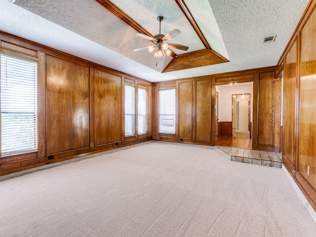 2011 Vicksburg Dr, Sachse, TX 75048 - interior space with a ceiling fan, a textured ceiling, plenty of natural light, visible vents, and wood walls