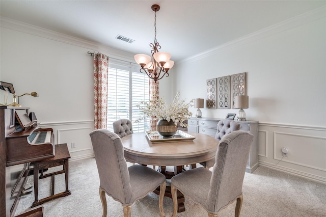 12067 Sunny St, Frisco, TX 75033 - dining area featuring a chandelier, ornamental molding, light colored carpet, a wainscoted wall, and a decorative wall