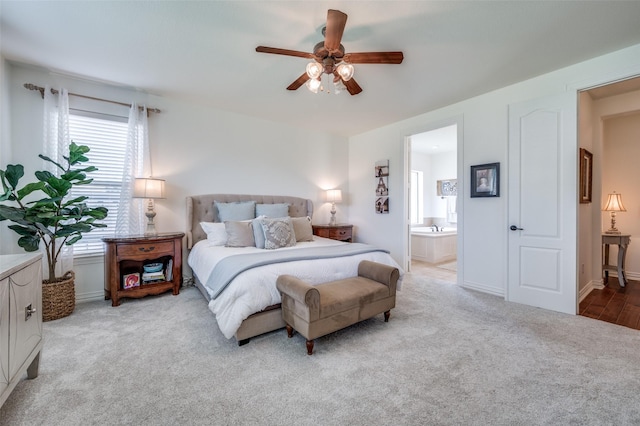 12067 Sunny St, Frisco, TX 75033 - bedroom with light colored carpet, multiple windows, ensuite bath, and a ceiling fan