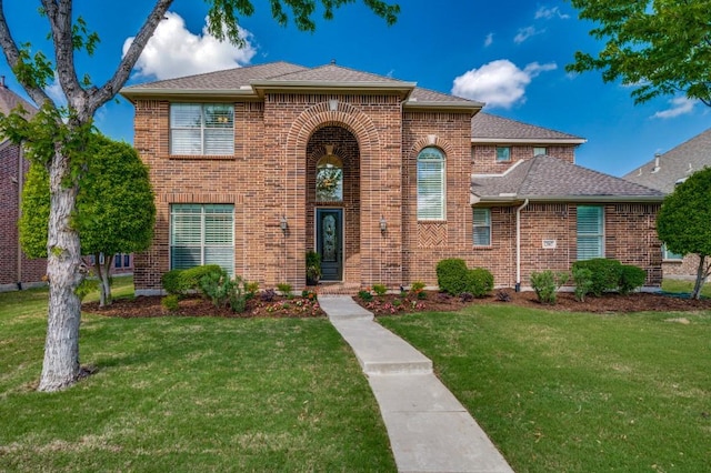 12067 Sunny St, Frisco, TX 75033 - traditional home with brick siding, a front yard, and a shingled roof