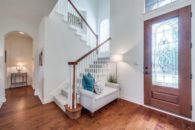 12067 Sunny St, Frisco, TX 75033 - entrance foyer featuring arched walkways, dark wood finished floors, stairway, and plenty of natural light