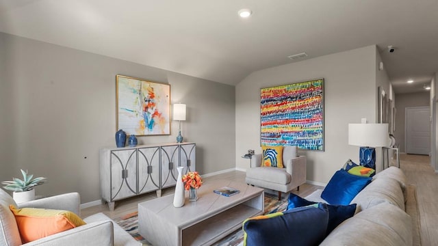 living area with visible vents, baseboards, recessed lighting, lofted ceiling, and wood finished floors