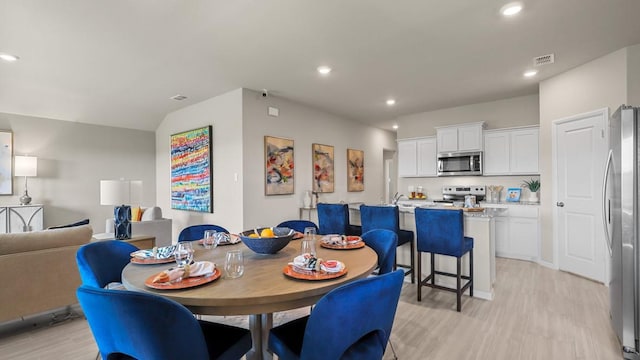 dining area with recessed lighting, light wood-type flooring, and visible vents