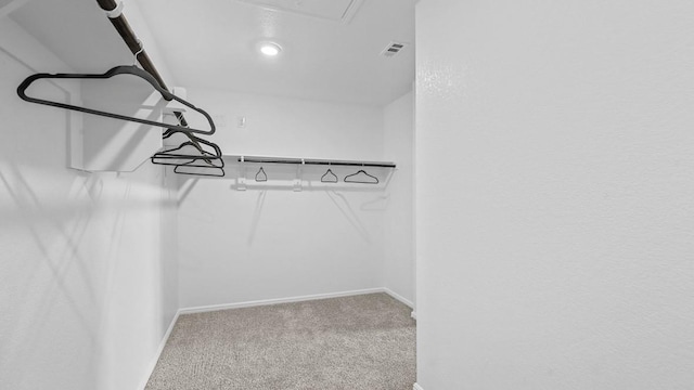 spacious closet featuring attic access, carpet, and visible vents
