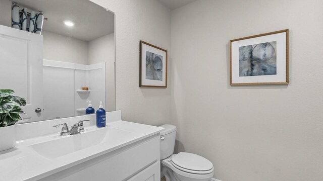bathroom with toilet and vanity