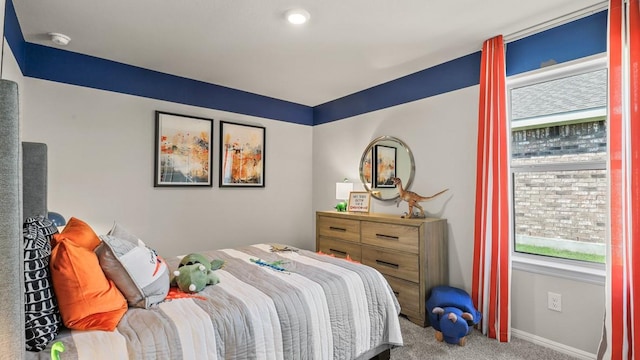 bedroom with baseboards and carpet