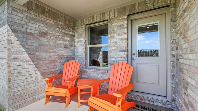 view of exterior entry with brick siding