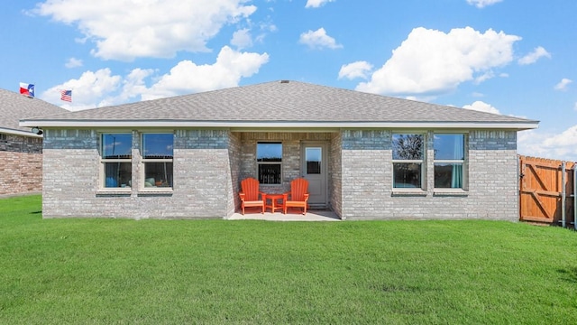 back of house with a patio area, brick siding, fence, and a yard