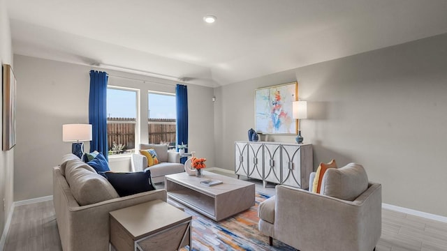 living room featuring light wood-type flooring, baseboards, and recessed lighting
