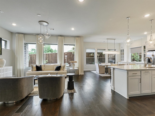 9136 Rock Daisy Ct, Dallas, TX 75231 - living area featuring dark wood-style flooring and recessed lighting