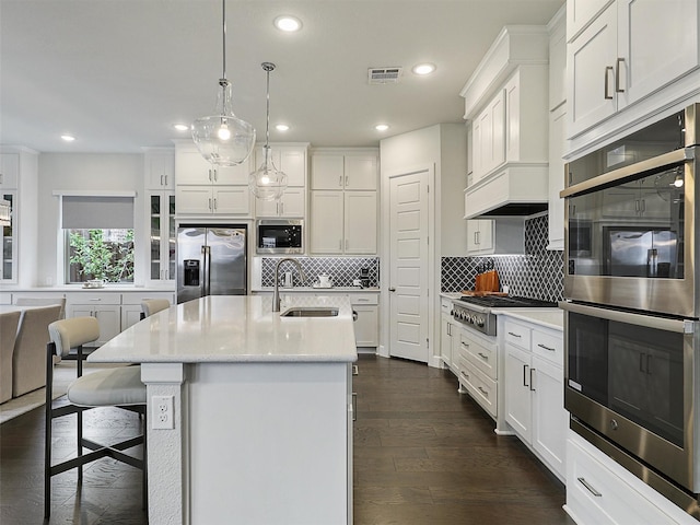 9136 Rock Daisy Ct, Dallas, TX 75231 - kitchen featuring appliances with stainless steel finishes, recessed lighting, backsplash, white cabinets, and dark wood finished floors