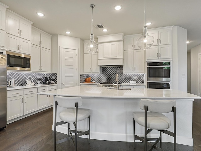 9136 Rock Daisy Ct, Dallas, TX 75231 - kitchen with stainless steel appliances, white cabinets, light countertops, and recessed lighting