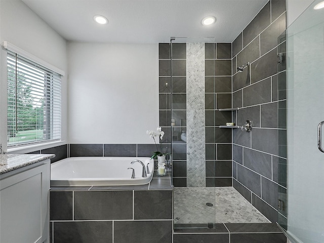 9136 Rock Daisy Ct, Dallas, TX 75231 - full bathroom with a garden tub, a tile shower, vanity, and recessed lighting
