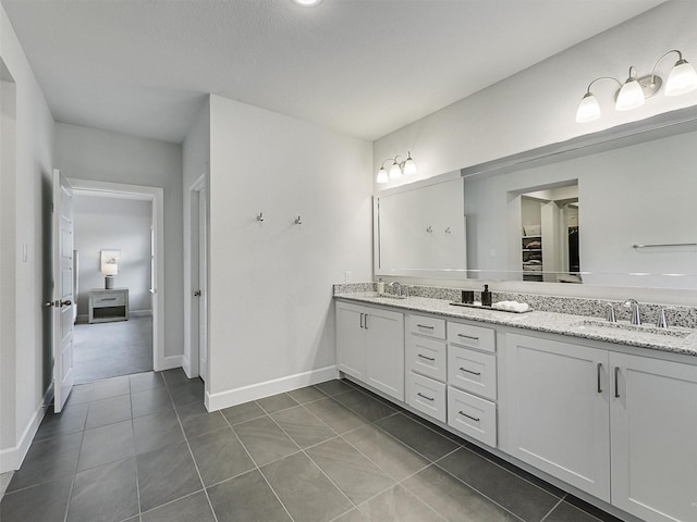 9136 Rock Daisy Ct, Dallas, TX 75231 - bathroom with double vanity and tile patterned floors