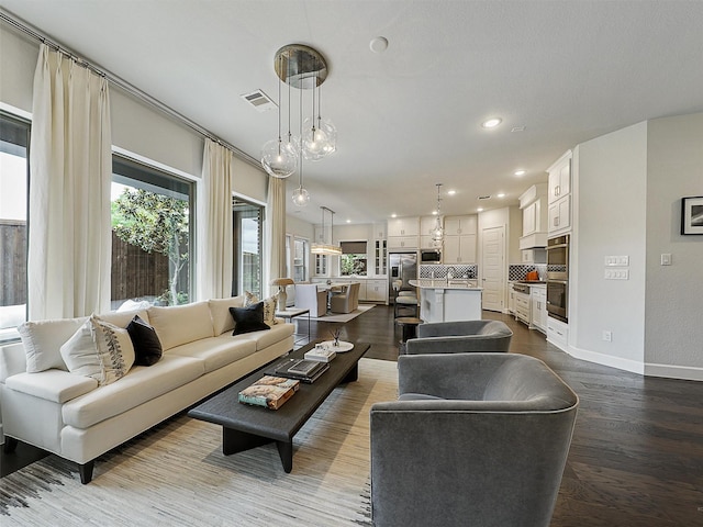9136 Rock Daisy Ct, Dallas, TX 75231 - living area featuring dark wood-type flooring and recessed lighting