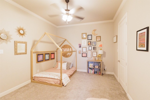 carpeted bedroom featuring ceiling fan, baseboards, and ornamental molding