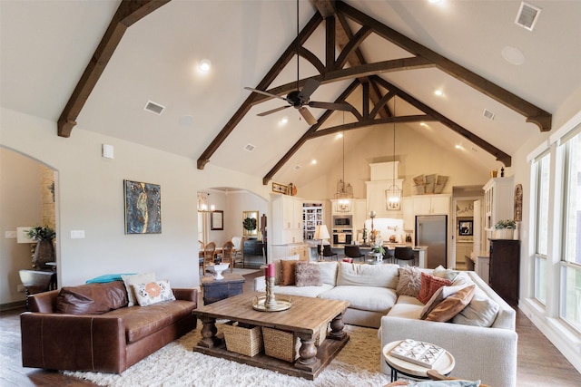 living area featuring high vaulted ceiling, arched walkways, beam ceiling, and visible vents