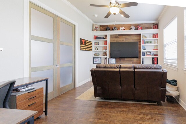 living room with wood finished floors, crown molding, and ceiling fan