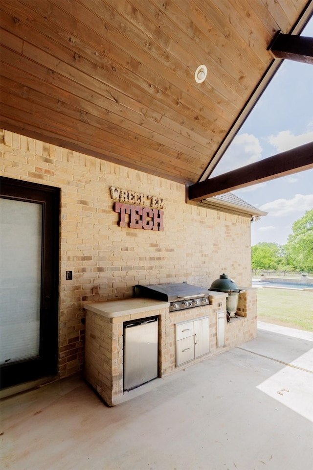 view of patio with area for grilling and a grill