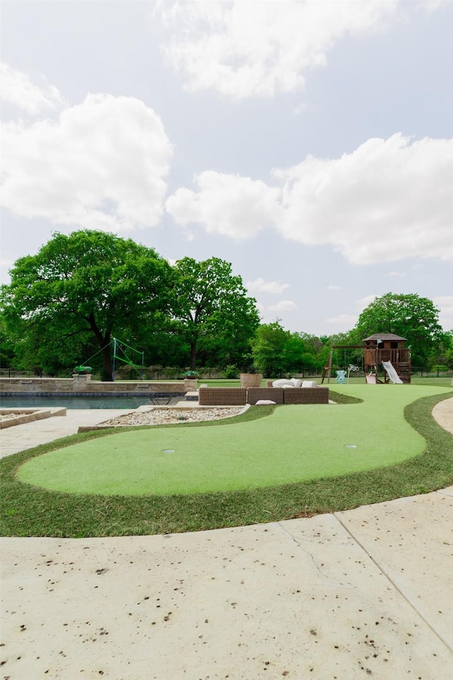 view of property's community with playground community and a swimming pool