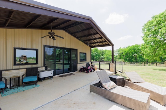 view of patio / terrace with fence and a ceiling fan