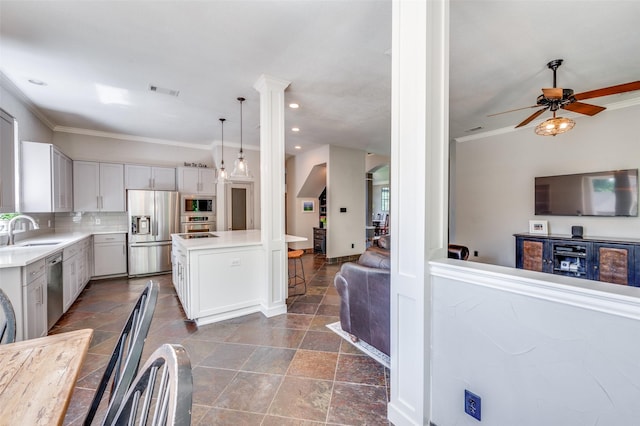 4007 Brooks Ct, Highland Village, TX 76226 - kitchen with stainless steel appliances, light countertops, a ceiling fan, a sink, and crown molding