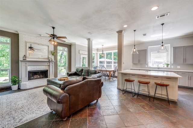 4007 Brooks Ct, Highland Village, TX 76226 - living room featuring a ceiling fan, visible vents, a wealth of natural light, and crown molding