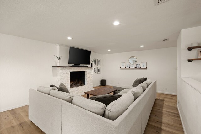 1764 Brown Trl, Hurst, TX 76054 - living room with a fireplace, baseboards, light wood-style floors, and recessed lighting