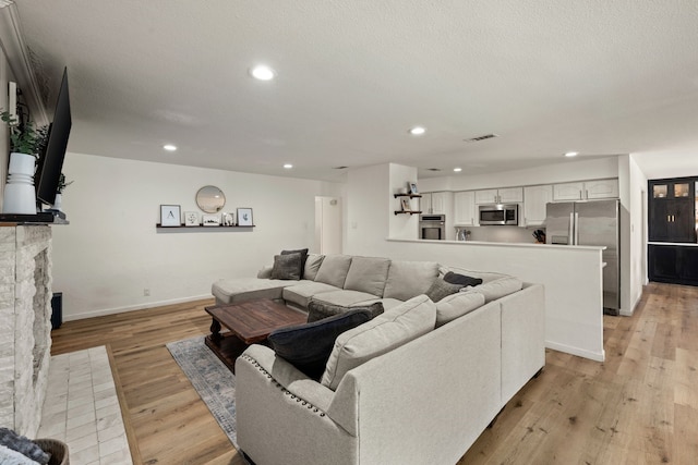 1764 Brown Trl, Hurst, TX 76054 - living area featuring baseboards, light wood-style flooring, recessed lighting, and a fireplace with flush hearth