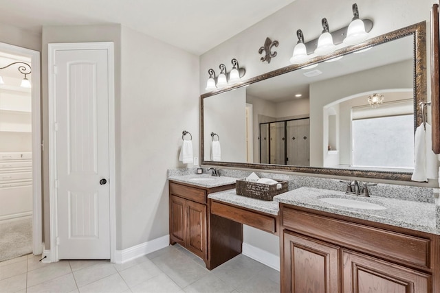full bathroom featuring a shower stall, tile patterned flooring, and a sink