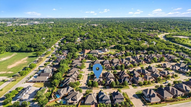 drone / aerial view with a forest view and a residential view