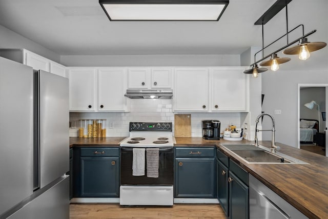 106 Rio Grande Dr, Crandall, TX 75114 - kitchen with under cabinet range hood, a sink, wooden counters, and appliances with stainless steel finishes