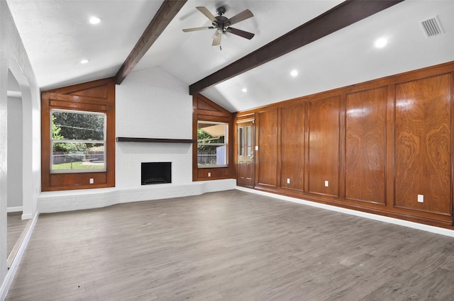 6709 Santiago Ave, Fort Worth, TX 76133 - unfurnished living room with a ceiling fan, wood finished floors, a brick fireplace, and baseboards