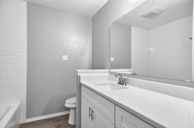 6709 Santiago Ave, Fort Worth, TX 76133 - bathroom featuring wood finished floors, toilet, vanity, baseboards, and a textured wall