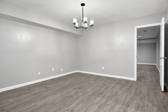 6709 Santiago Ave, Fort Worth, TX 76133 - unfurnished room featuring dark wood-style floors, a chandelier, and baseboards
