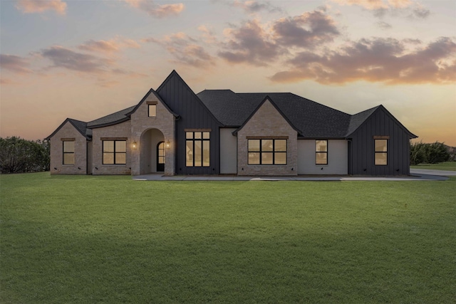 7103 Heathington Ct, Granbury, TX 76049 - view of front of home with board and batten siding and a yard