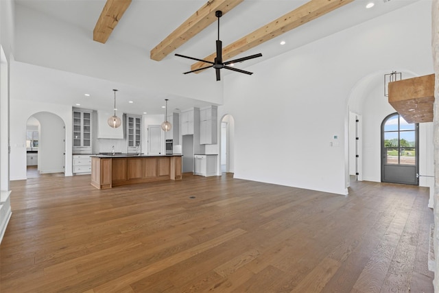 7103 Heathington Ct, Granbury, TX 76049 - unfurnished living room with light wood-type flooring, arched walkways, a ceiling fan, and recessed lighting
